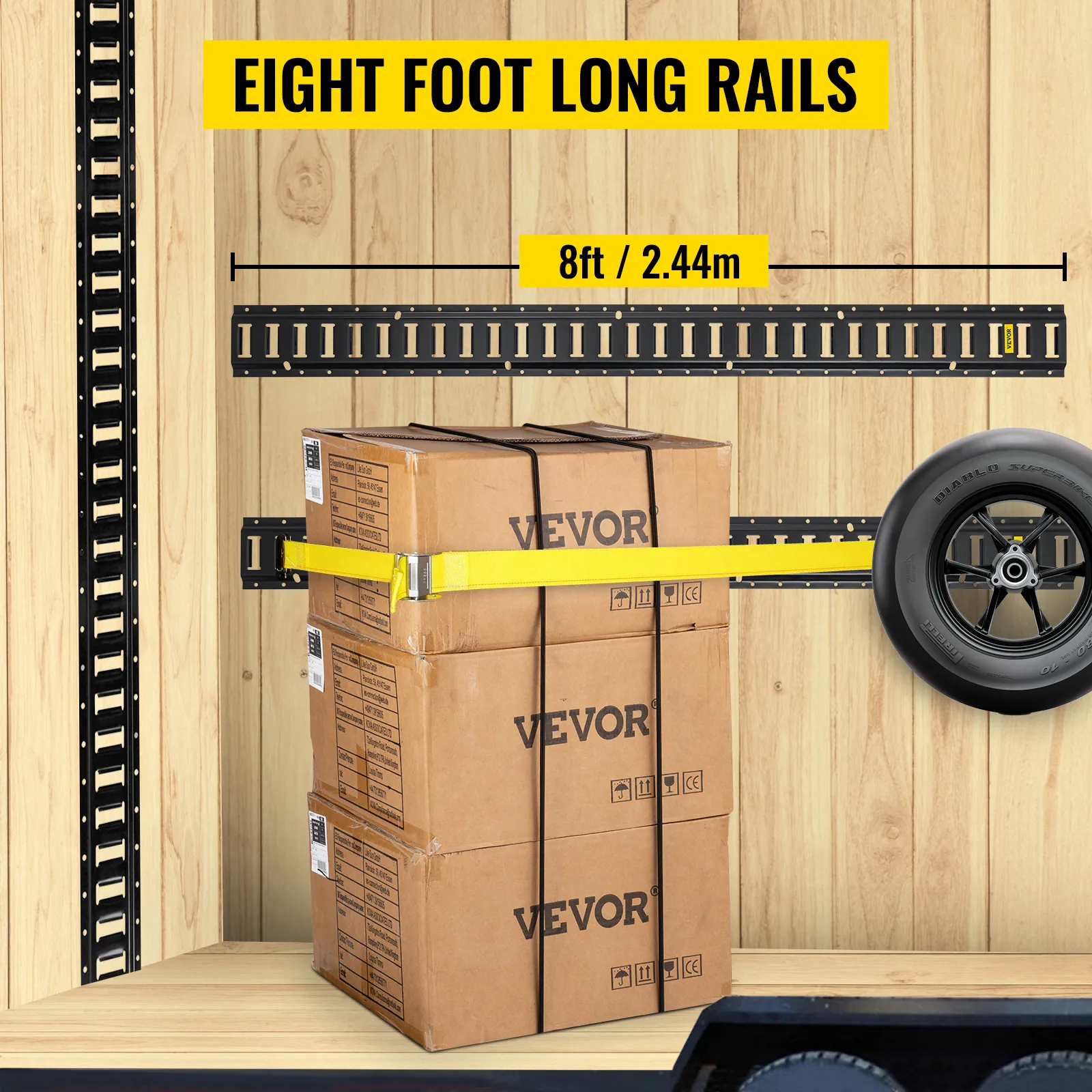 VEVOR e-track tie-down rail holding three stacked boxes, with a tire secured on wooden wall.