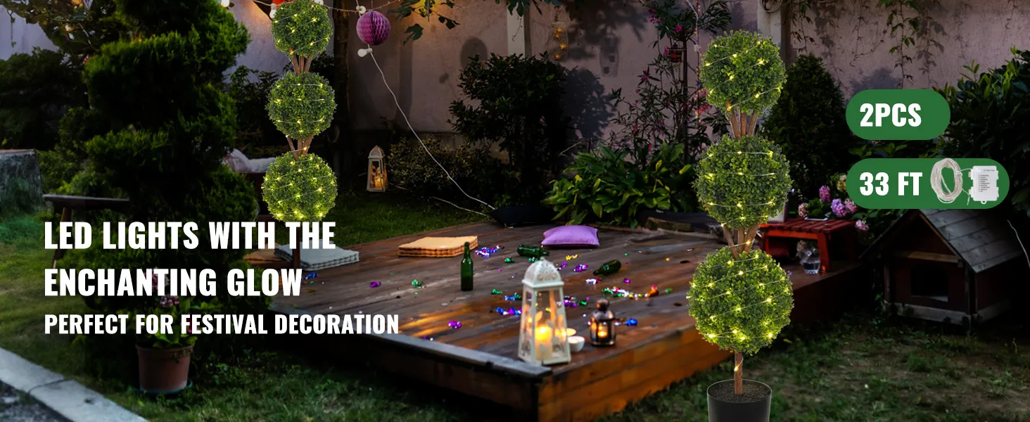 VEVOR artificial topiaries with led lights illuminating a festive, outdoor garden setting.