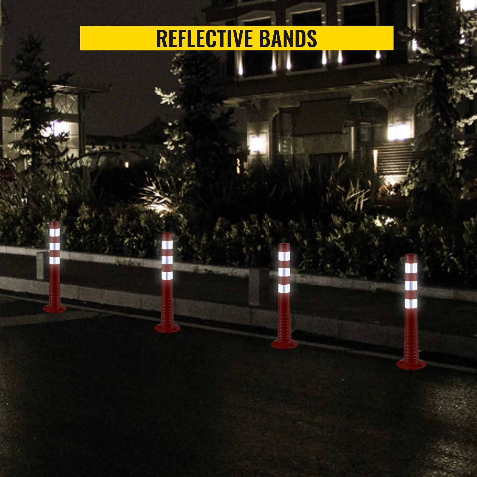 VEVOR traffic delineator cones with reflective bands in front of a building at night.