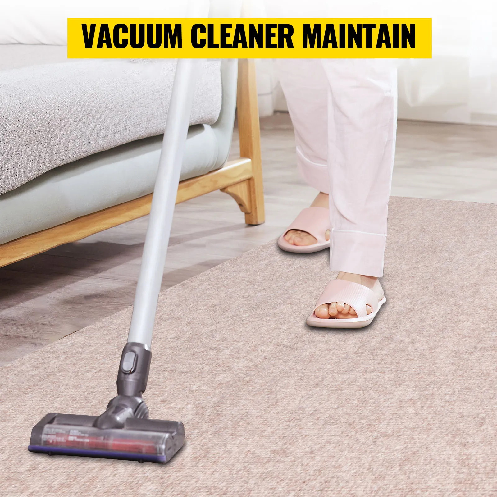 vacuum cleaner maintaining carpet next to a couch in a bright living room.