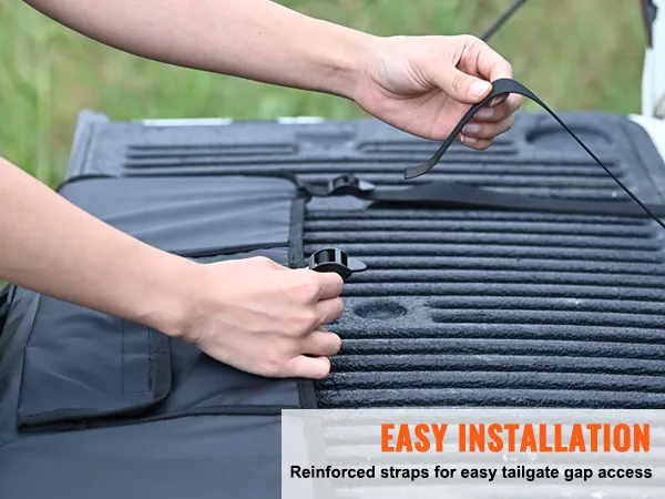 hands adjusting reinforced straps of VEVOR tailgate pad for easy installation and tailgate gap access.