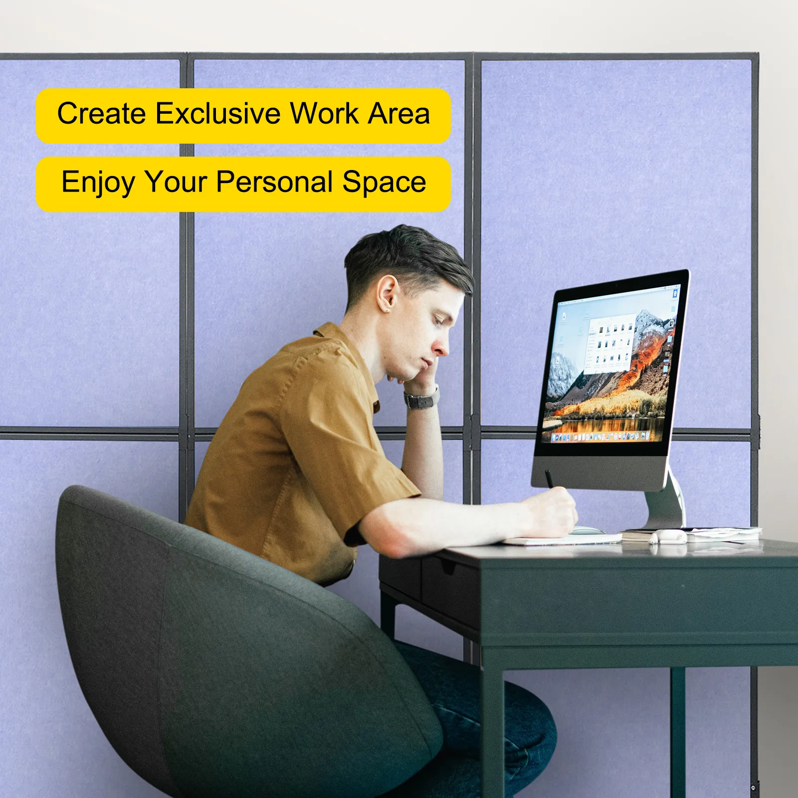 person working at a desk in front of a VEVOR acoustic room divider.