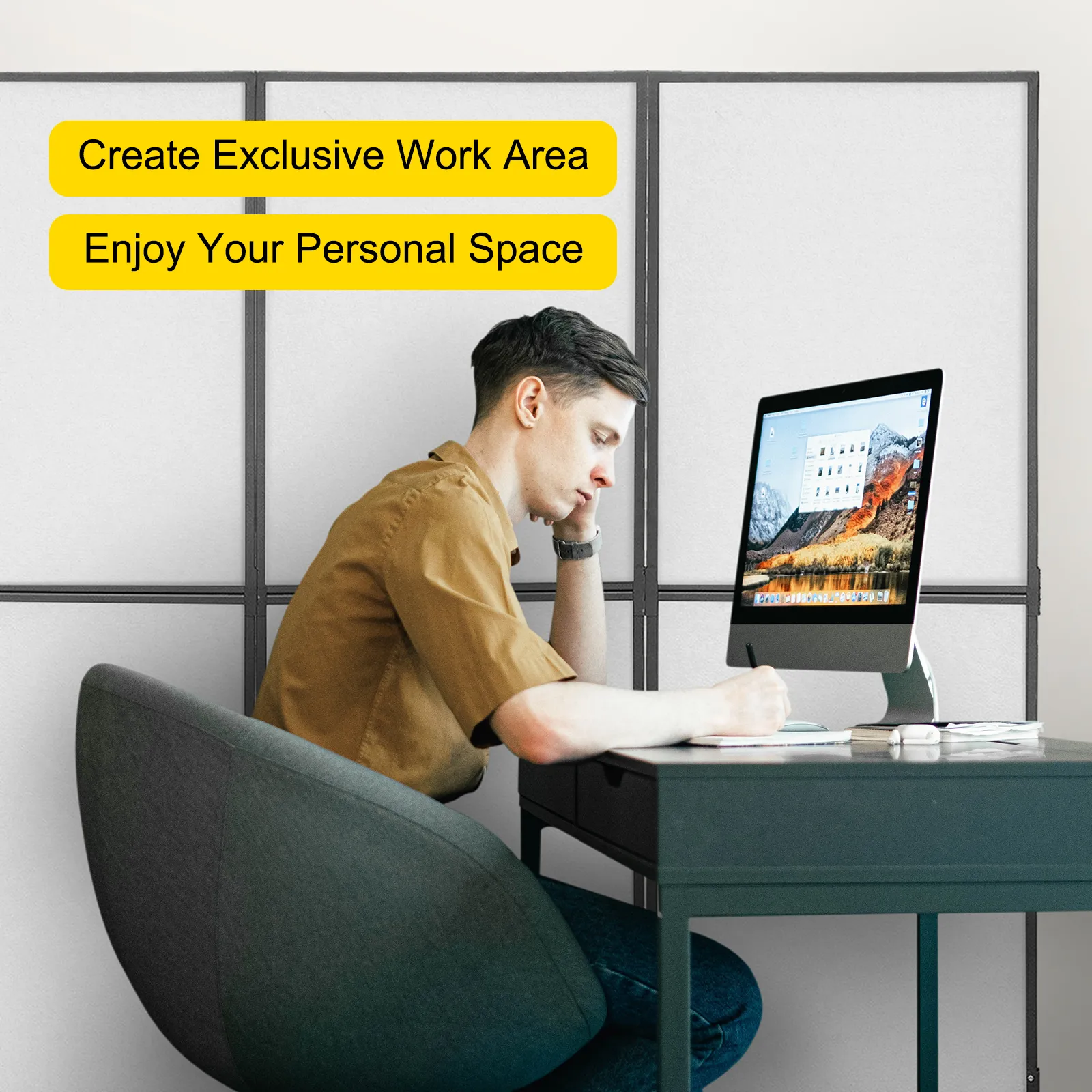 person working at a desk with a VEVOR acoustic room divider in the background.