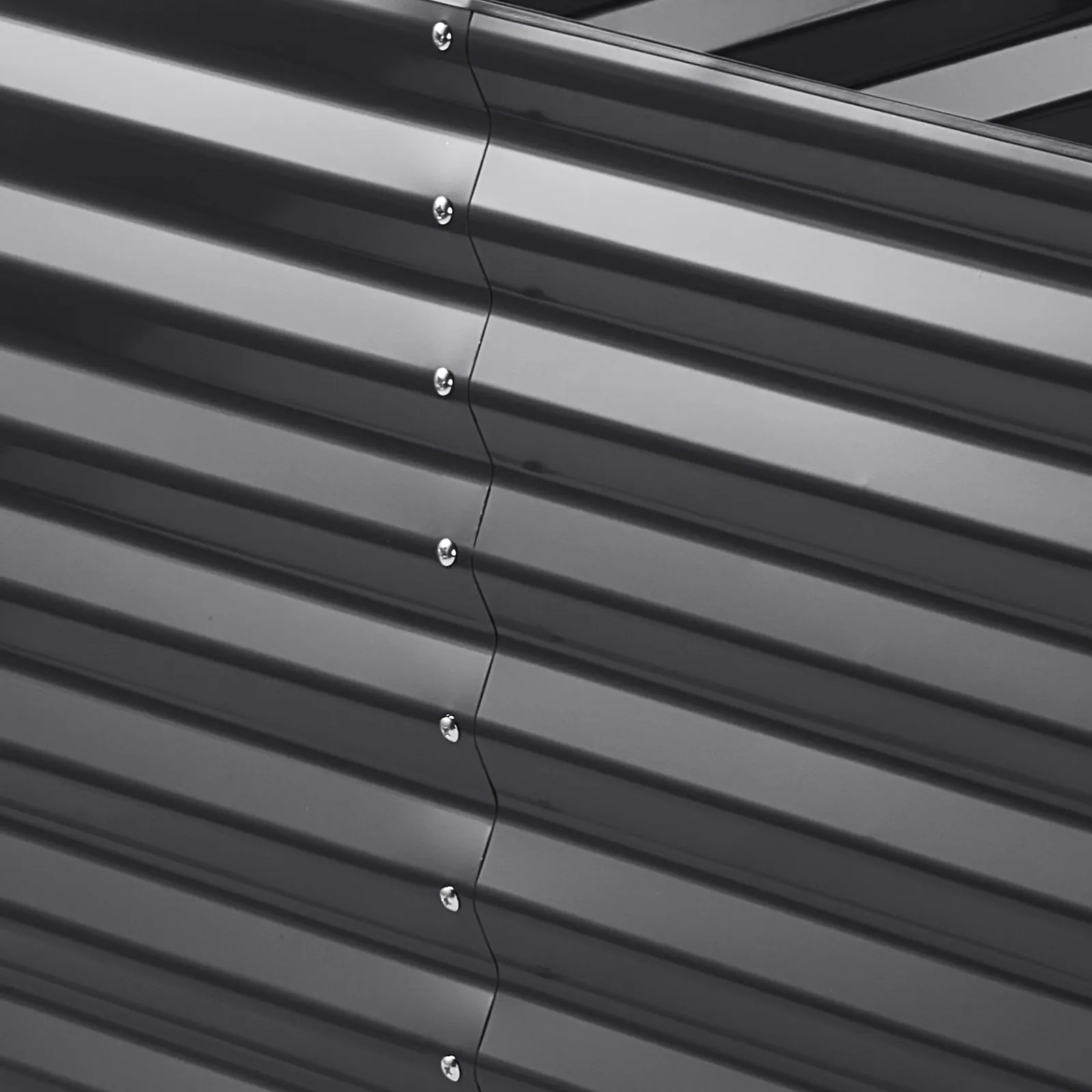 close-up of a steel VEVOR garden bed with corrugated panels and silver screws.