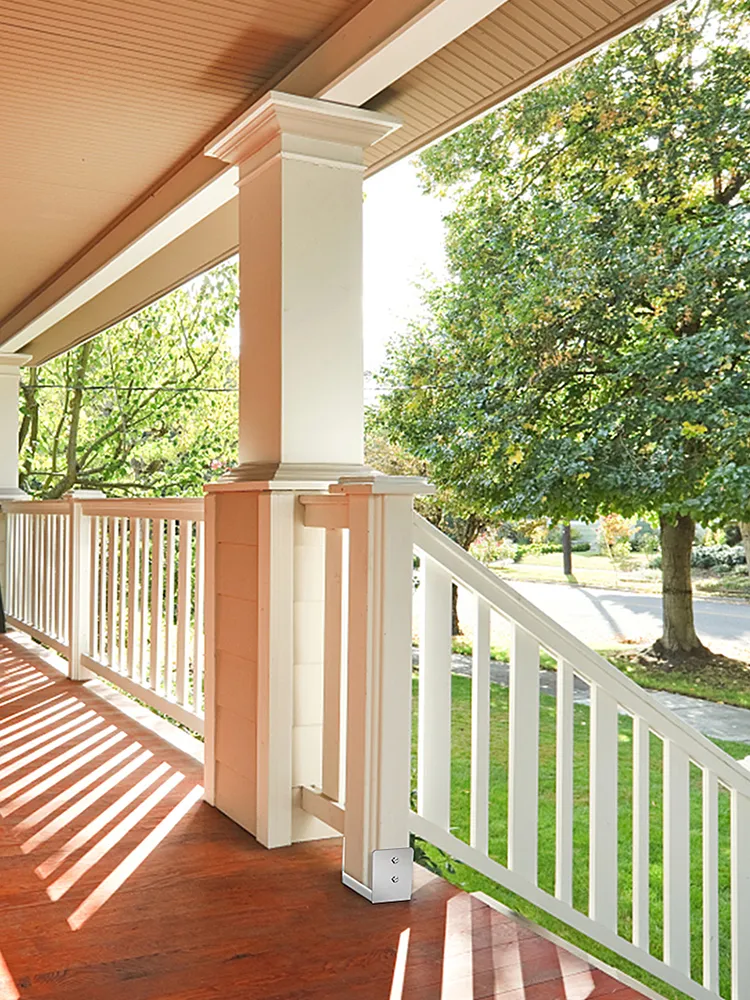 VEVOR standoff post base installed on a porch column with railing and wooden floor.