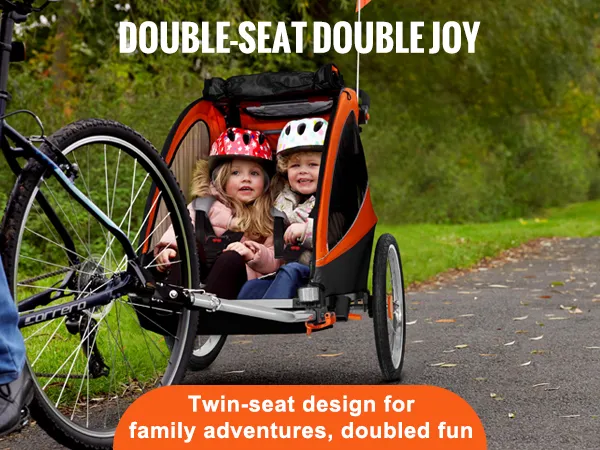 twin-seat VEVOR bike trailer for toddlers attached to bike on a scenic park path with labeled routes.