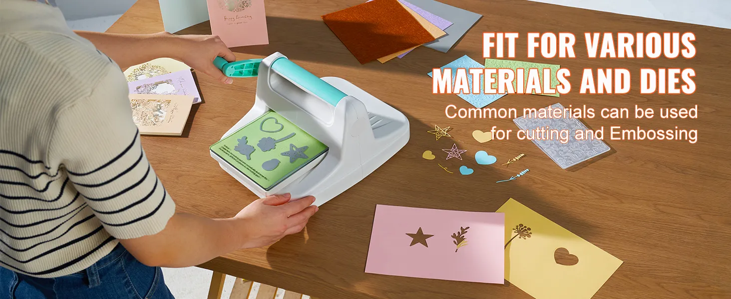 person using VEVOR die cutting machine on various materials and dies with cards on a wooden table.