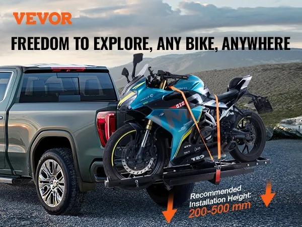 VEVOR motorcycle carrier attached to a pickup truck, securing a blue motorcycle against a mountain backdrop.