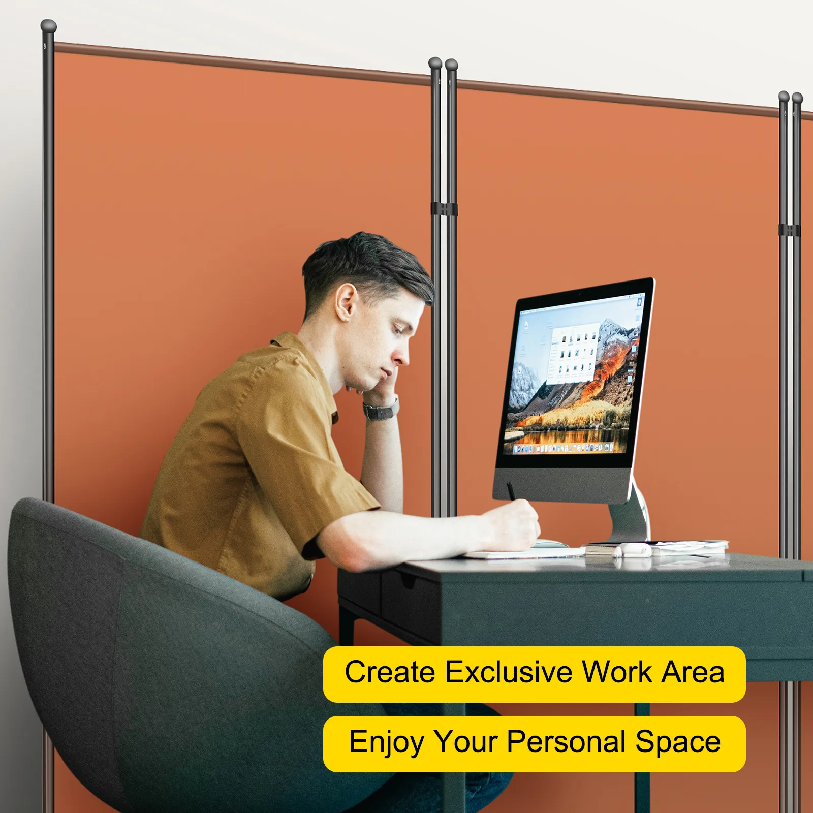 person working at a desk with a computer, using VEVOR office partition for privacy.