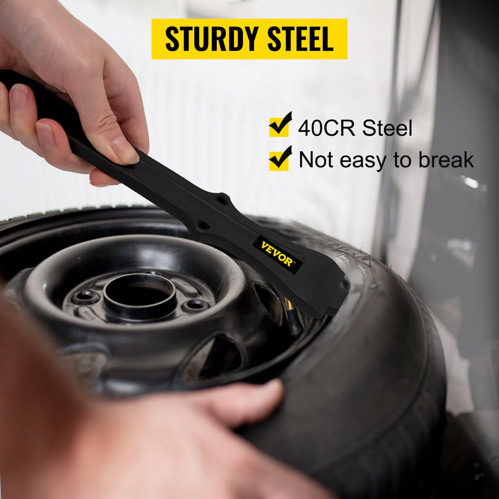 hand using VEVOR tire changing tool made of sturdy 40cr steel on a car tire.