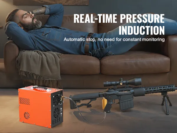 VEVOR pcp air compressor next to a rifle on the floor while a person relaxes on a couch in the background.