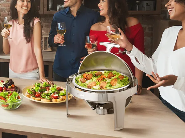 group of friends enjoying wine and canapés around a VEVOR roll top chafing dish on a wooden table.