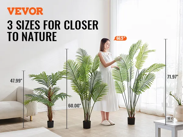 3 sizes of VEVOR artificial palm tree displayed beside a couch in a bright, modern room.