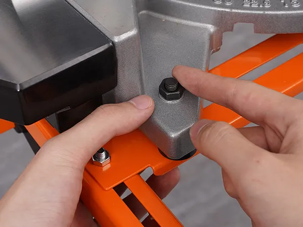 tightening screws on a VEVOR miter saw stand bracket with hands for secure mounting.