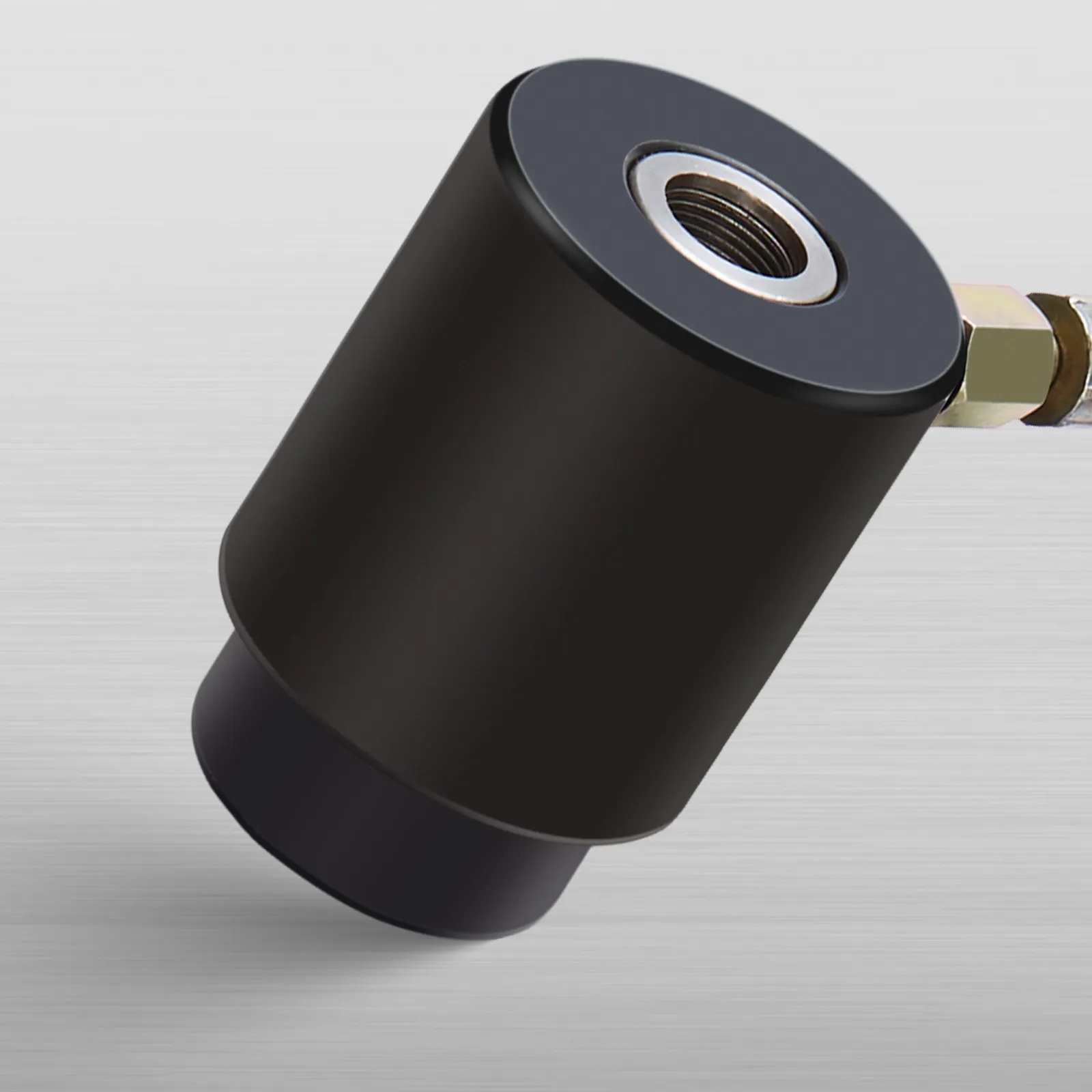 black cylindrical part of the VEVOR knockout punch driver kit against a brushed metal background.