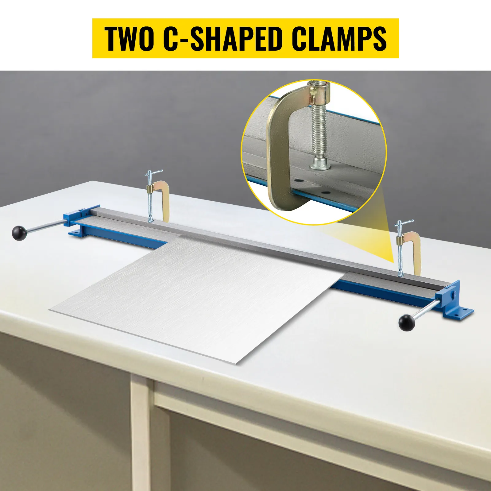 VEVOR sheet metal brake with two c-shaped clamps on a workbench.