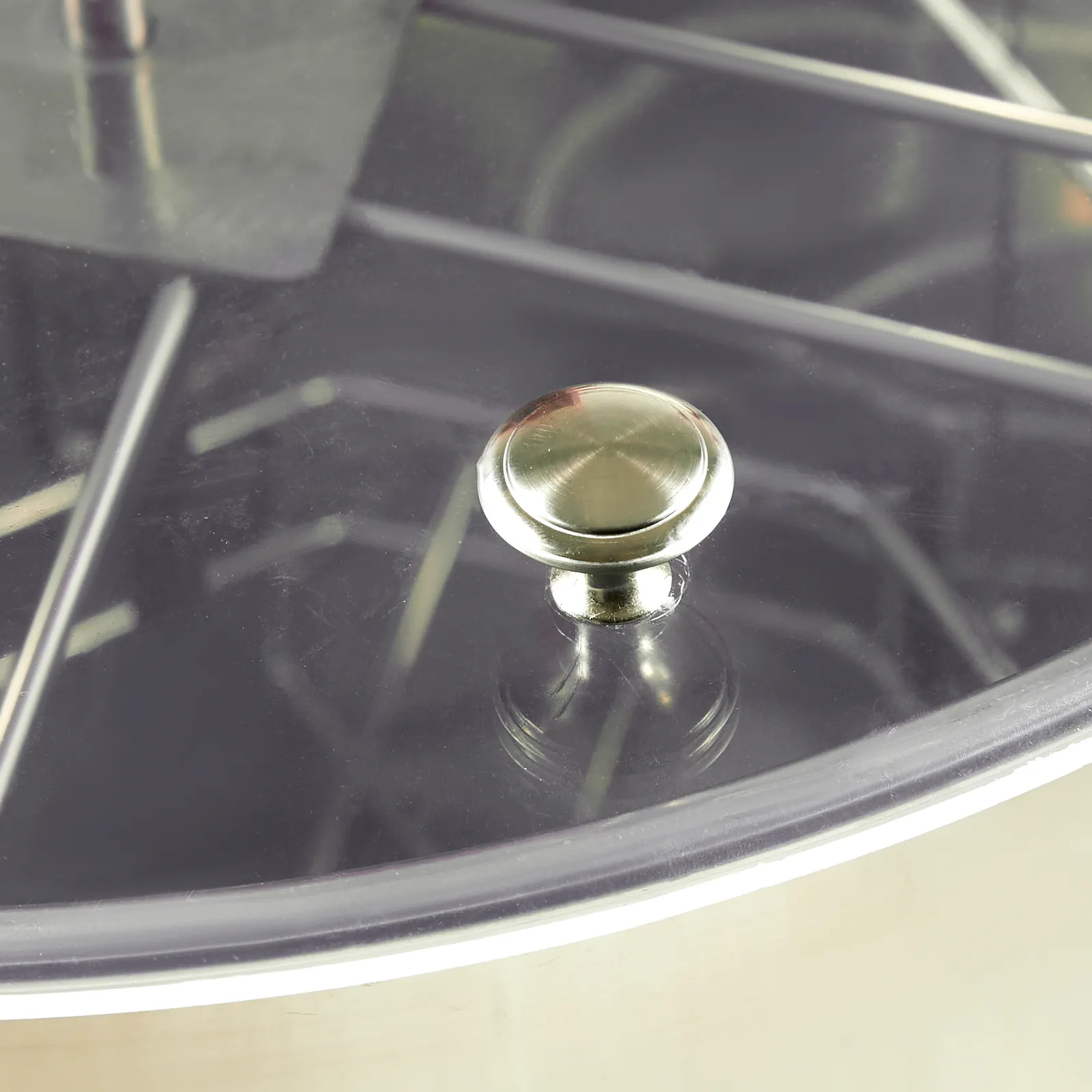 metallic knob and wireframe structure of a VEVOR honey extractor with clear view of its interior.