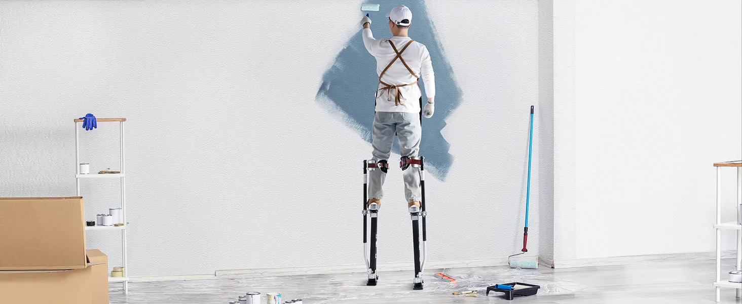 painter using VEVOR drywall stilts to paint a wall, surrounded by painting tools and supplies.