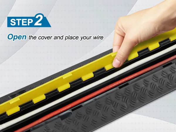hand lifting cover of VEVOR cable protector ramp to place wires inside, highlighting step 2 of process.