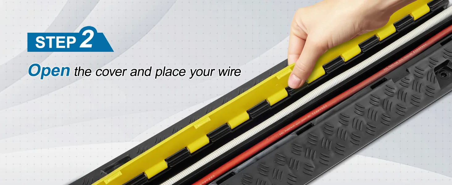 hand lifting cover of VEVOR cable protector ramp to place wires inside, highlighting step 2 of process.