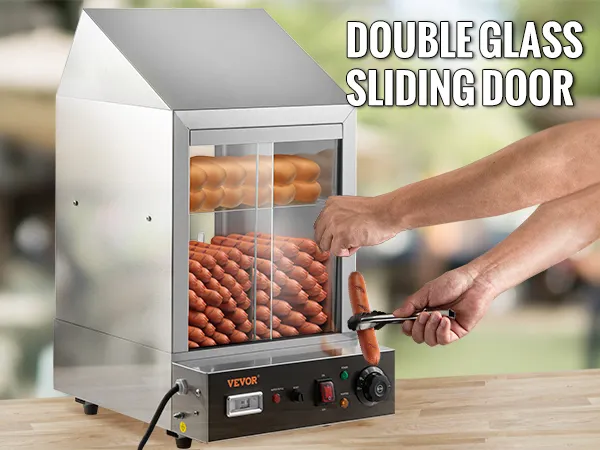 Vaporera para hot dogs VEVOR con puerta corrediza de vidrio doble y exterior de acero inoxidable sobre encimera de madera.