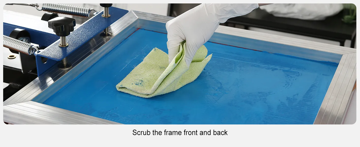 gloved hand scrubbing a blue screen frame using the VEVOR screen printing kit.