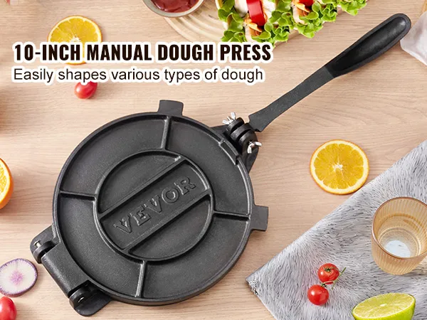 VEVOR tortilla press with handle on wooden table, surrounded by fresh fruits, vegetables, and pizza.