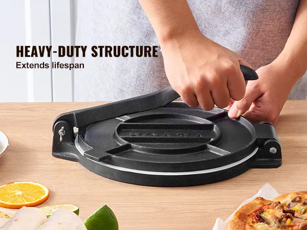 person using VEVOR tortilla press with dough, fruits, and pizza on a wooden table, highlighting heavy-duty structure.