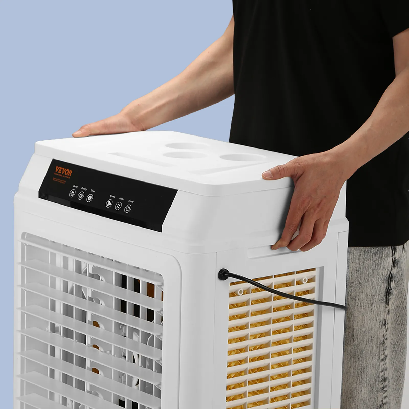 person adjusting the control panel of a VEVOR evaporative air cooler, shown from the side.