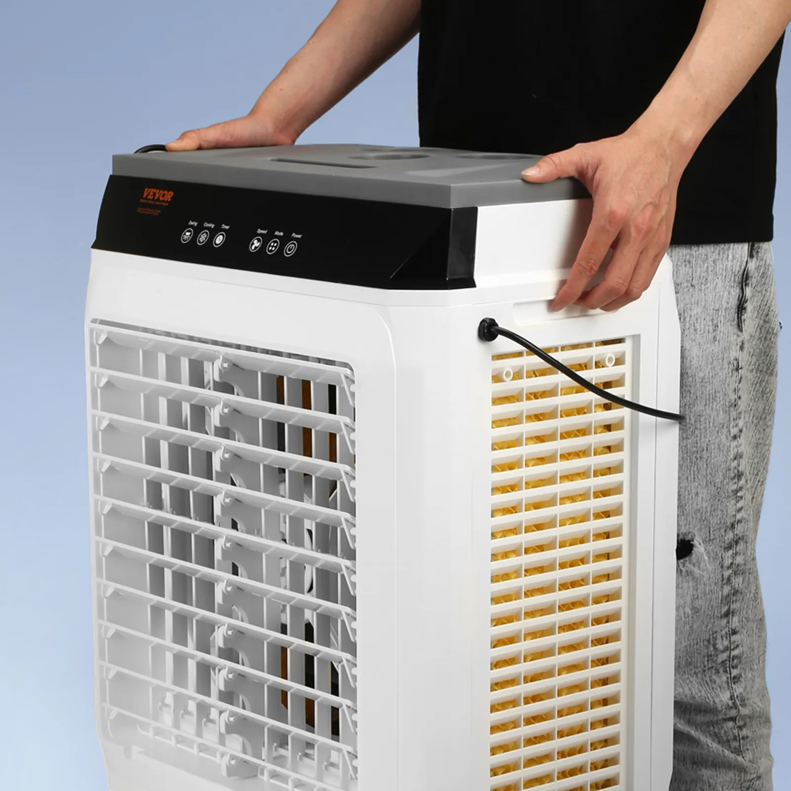 person adjusting the VEVOR evaporative air cooler with visible control panel and air vents.