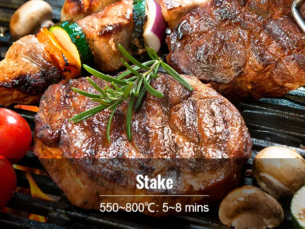 grilled steak with tomatoes, mushrooms, and skewered vegetables on VEVOR ceramic grill.