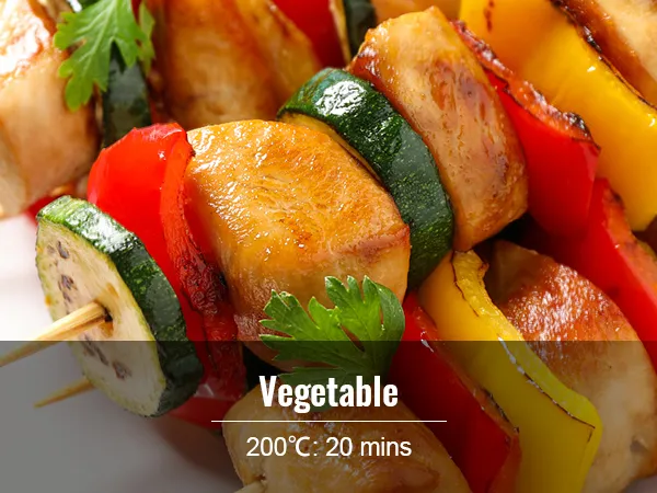 grilled vegetable skewers with zucchini, peppers, and chicken on a white plate, 200°c for 20 mins.