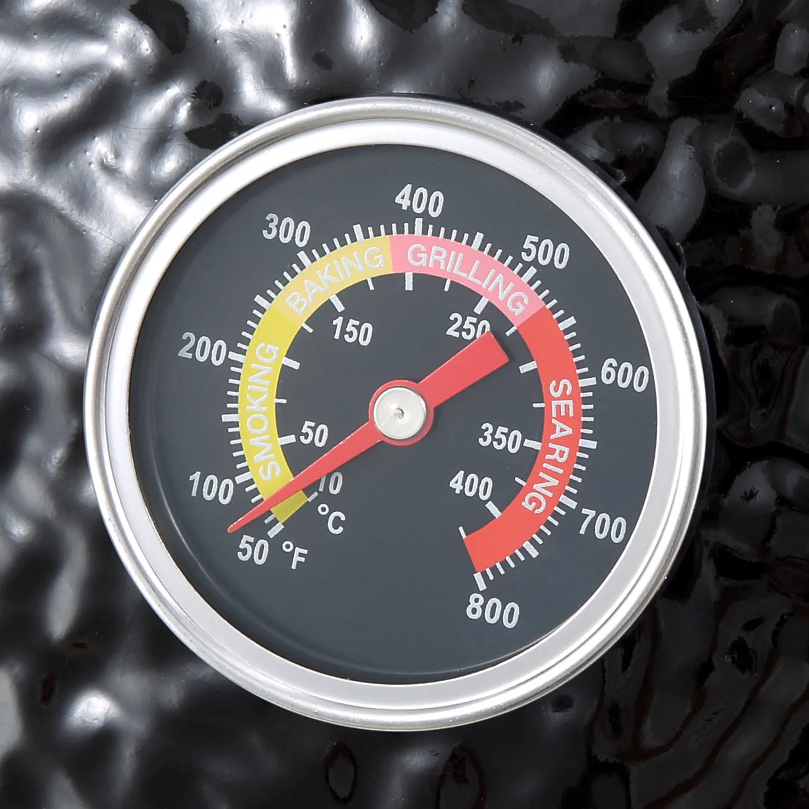 close-up of a thermometer on a VEVOR ceramic barbecue grill with smoking, baking, grilling, and searing zones.