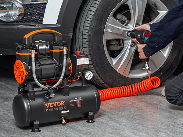 VEVOR ultra quiet air compressor in use, inflating a car tire with an orange hose.