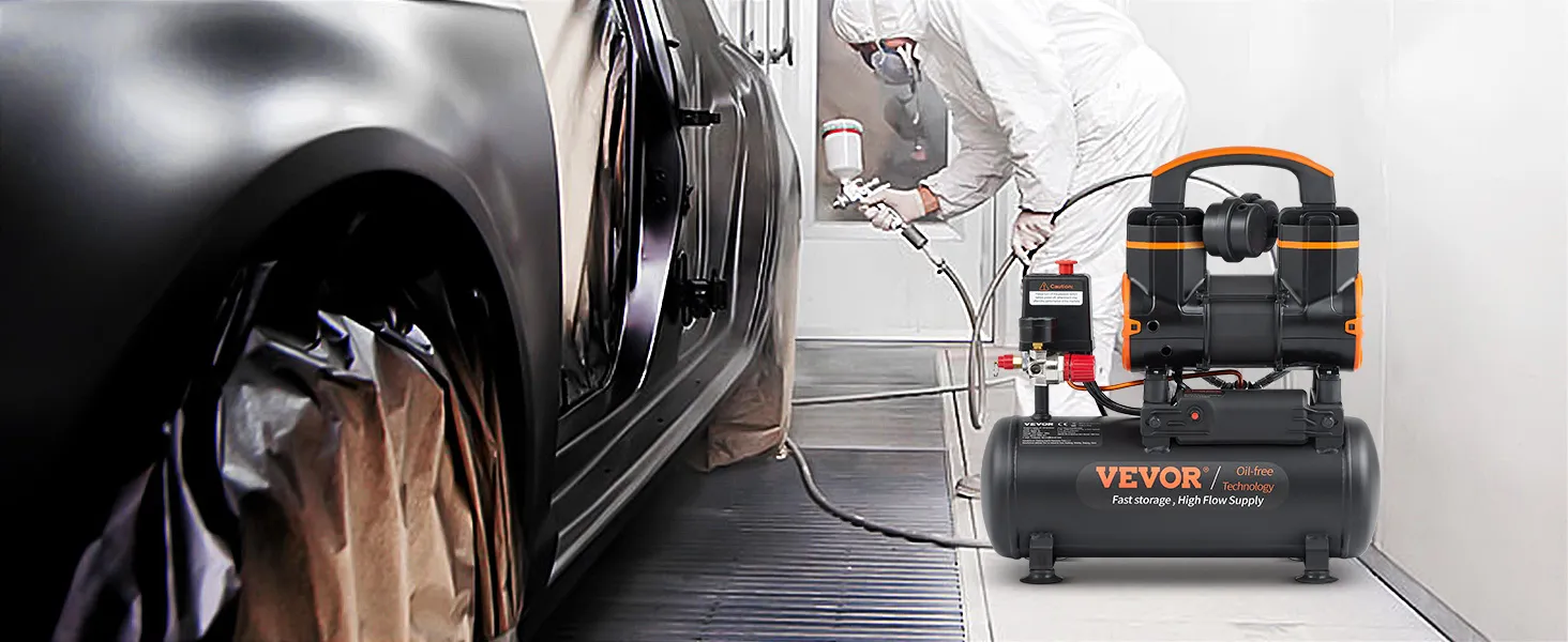 spray painter using VEVOR ultra quiet air compressor on black car in workshop.