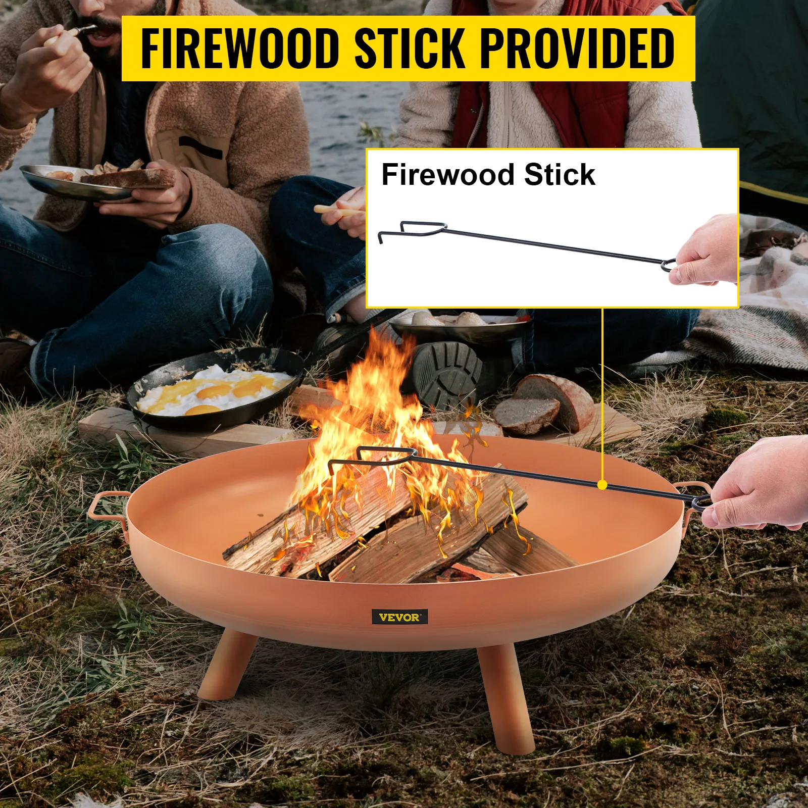 VEVOR fire pit bowl with firewood stick, surrounded by people eating outdoors.
