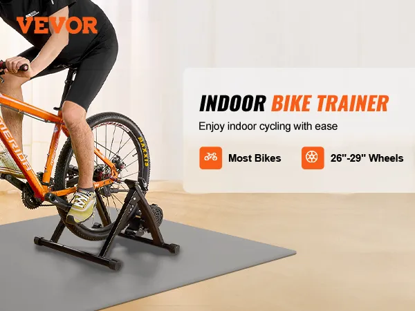 cyclist using VEVOR bike trainer stand for indoor training with orange bike on a training mat.