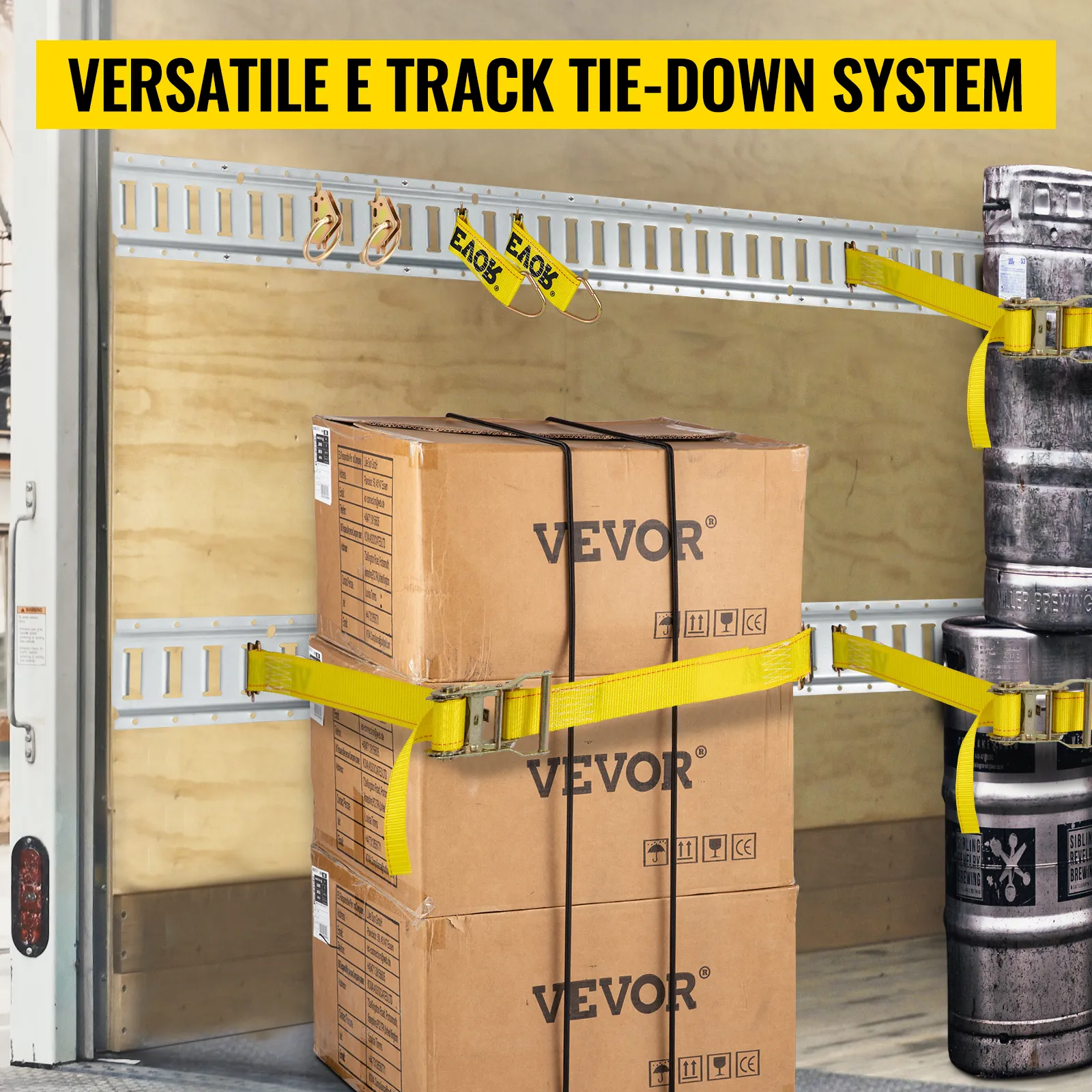 VEVOR e track tie-down rail kit securing boxes and metal barrels in a truck with yellow straps
