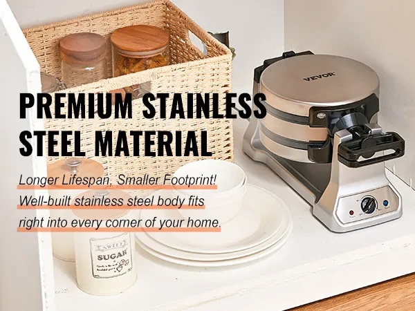 Máquina para hacer gofres VEVOR con cuerpo de acero inoxidable junto a una cesta tejida y utensilios de cocina de cerámica en un armario.