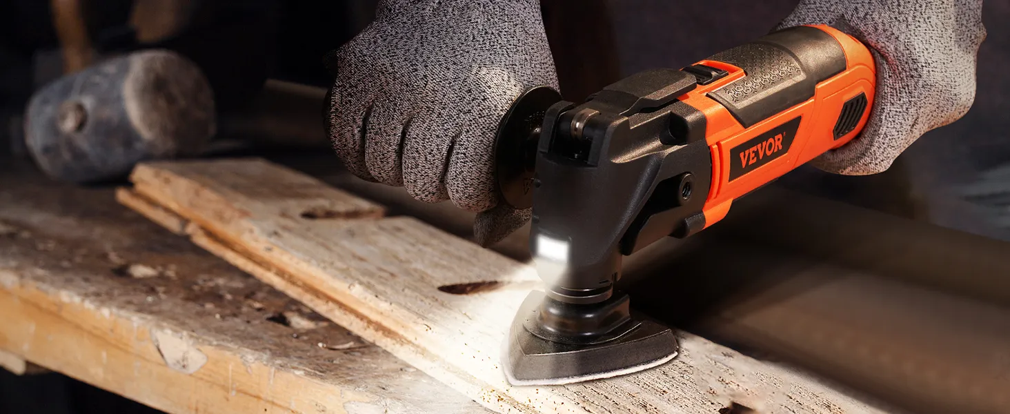 person using VEVOR oscillating tool with gloves on a wooden surface in a workshop.