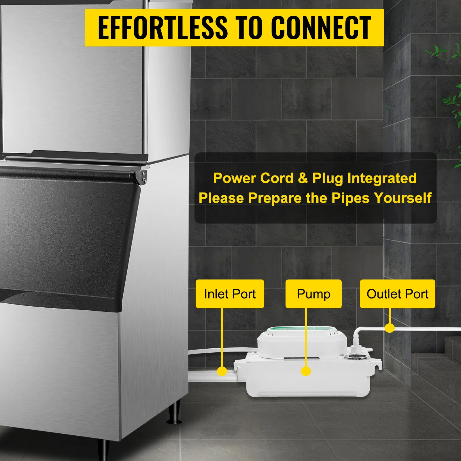 Bomba de condensado VEVOR resaltada debajo de un congelador con puertos de entrada y salida etiquetados.