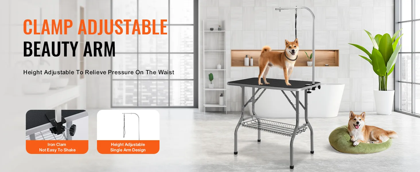 dog standing on VEVOR pet grooming table with adjustable arm, another dog resting on a green cushion nearby.