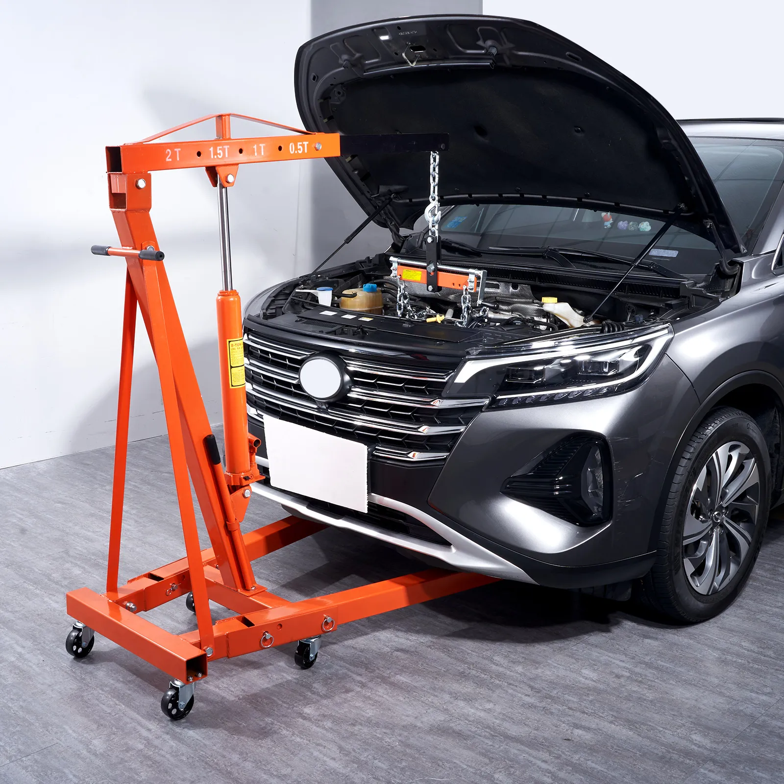 VEVOR hydraulic engine hoist lifting car engine hood open in a garage setup.
