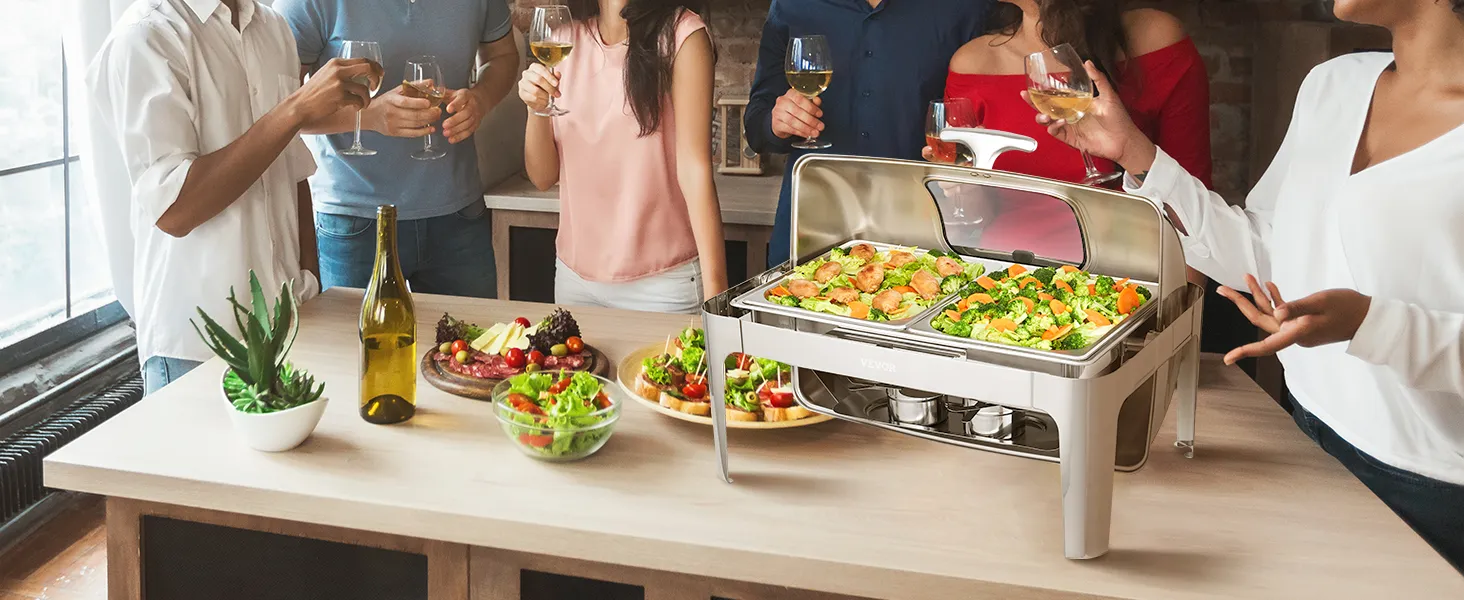 people enjoying food and drinks around a VEVOR chafing dish filled with hot appetizers at a gathering.