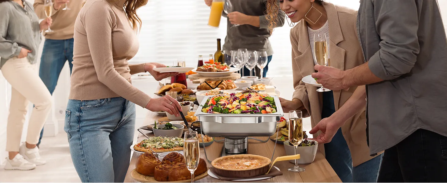 people enjoying a buffet with VEVOR chafing dish set, various dishes, and beverages on a table.