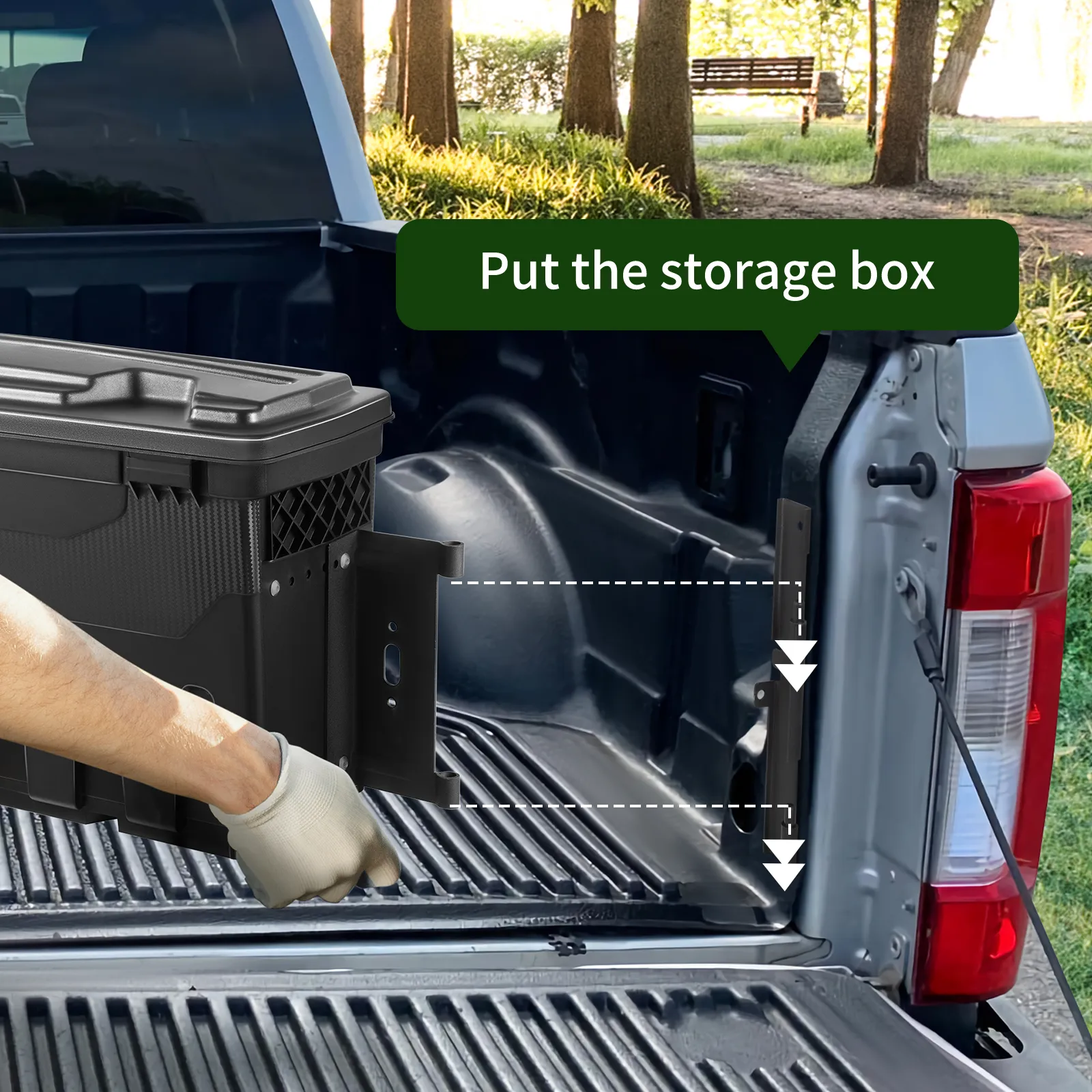 hand placing a VEVOR truck bed storage tool box into a pickup truck bed with trees in the background.
