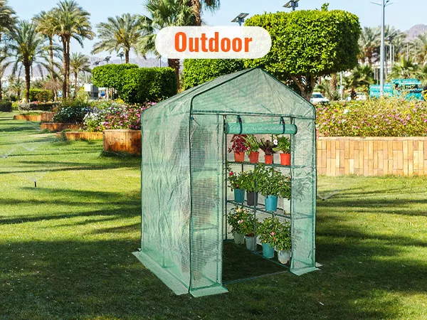 VEVOR walk-in greenhouse in a lush garden, featuring potted plants and a sunny outdoor setting.