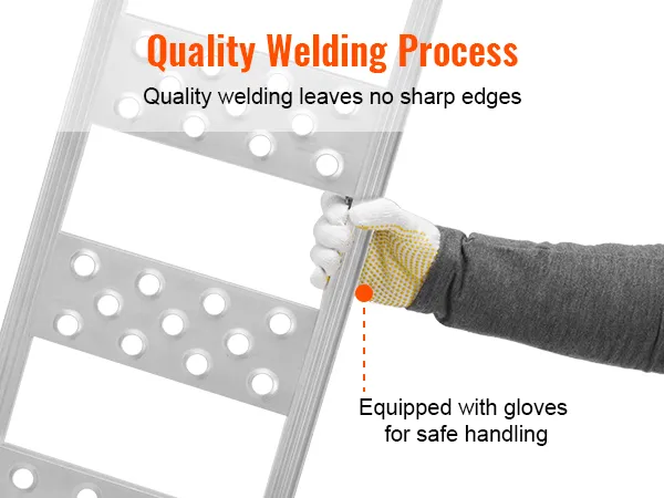 person using VEVOR aluminum loading ramps with gloves for safe handling and smooth welding edges.