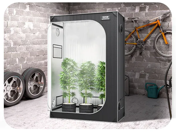 VEVOR grow tent in a garage with plants inside, next to a green grill, spare tires, and an orange bike.